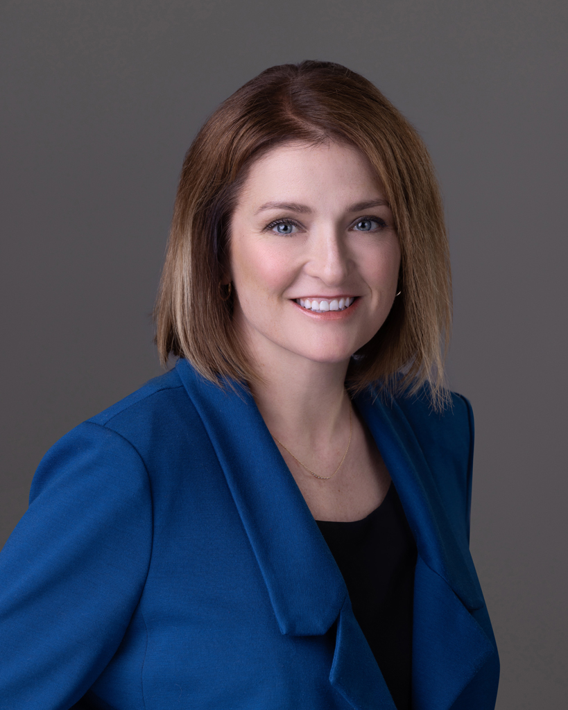 Normal Illinois headshot photographer. This Town of Normal employee is wearing a blue blazer and a black shirt.