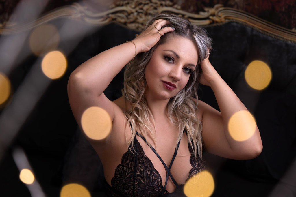 Best boudoir photographer bloomington illinois, Peoria, Illinois. She is wearing black lingerie with beach wave curls.