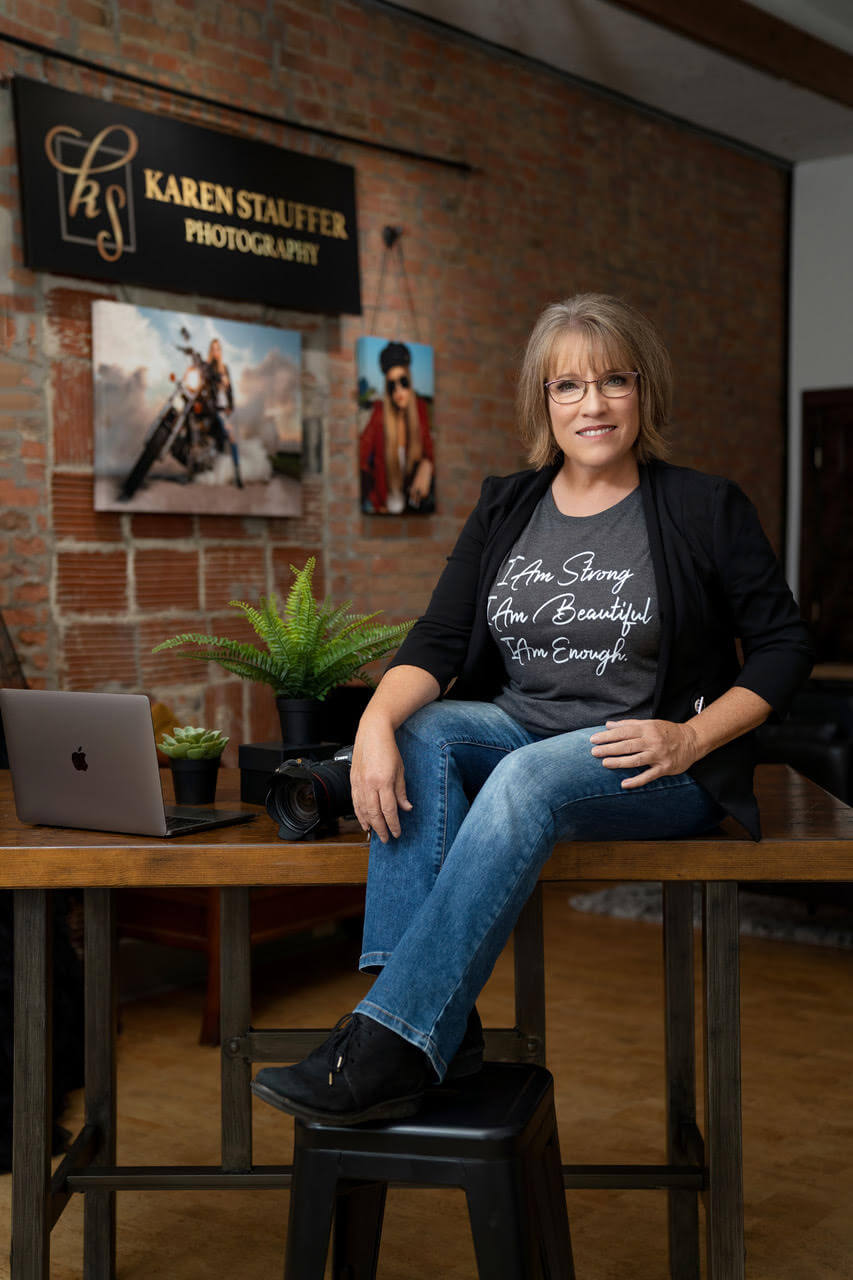 Karen Stauffer sitting in her photography studio in Bloomington.